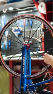 Someone testing the spokes of a bike